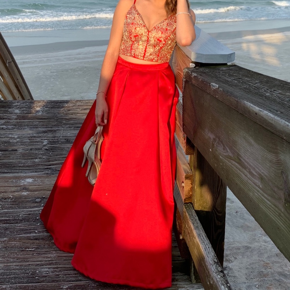 A red two-piece dress with gold embroidery